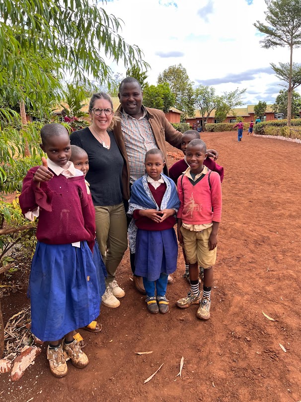 A volunteer with children at a partner school